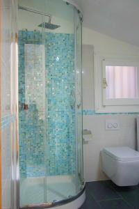 a bathroom with a glass shower with a toilet at Casa Valery Wonderful Sea View in Porto Rotondo
