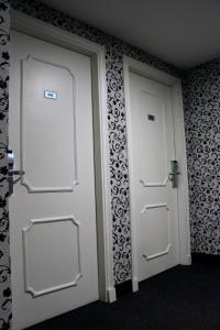 a bathroom with a door open and a white toilet at Centuria Hotel Buenos Aires in Buenos Aires