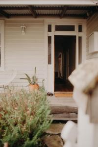 an open door to a porch of a house at The Allotment Albany - Centrally Located Cottage in Old Albany in Albany