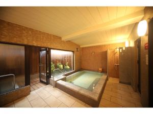 Una cama o camas en una habitación de KusatsuOnsen AeruyadoTakamatsu