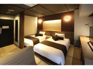 Una cama o camas en una habitación de KusatsuOnsen AeruyadoTakamatsu