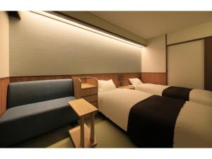 Una cama o camas en una habitación de KusatsuOnsen AeruyadoTakamatsu
