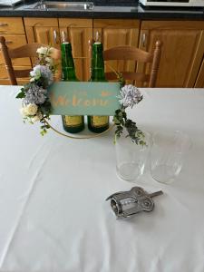a table with two bottles of wine and two glasses at Casa la melliza VV-3021AS in Mestas de Con +6 photos