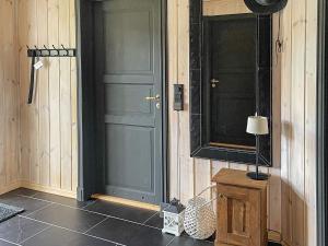 a room with a blue door and a table with a lamp at 10 person holiday home in veggli-By Traum in Veggli +31 photos
