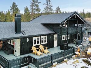 a large house with a deck with two chairs at 10 person holiday home in veggli-By Traum in Veggli