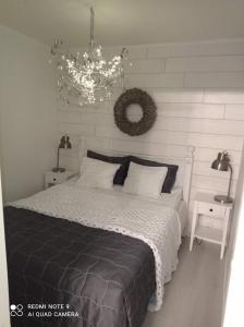 Schlafzimmer mit einem Bett und einem Kronleuchter in der Unterkunft Rantahiekka B1 in Kalajoki