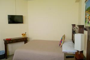Posteľ alebo postele v izbe v ubytovaní Hostal Donde Regina