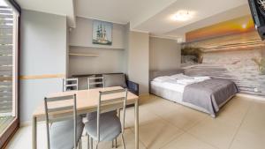 Łóżko lub łóżka w pokoju w obiekcie Apartamenty Sun & Snow Lido Sarbinowo