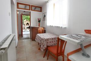 a kitchen with a table and a table and chairs at Apartment Roxor in Portorož