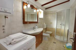 Un baño con lavabo, ducha e inodoro. en Apartment Roxor, en Portorož
