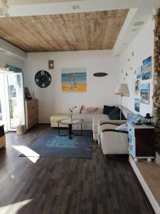 a living room with a couch and a table at SunnyDay House in Masline