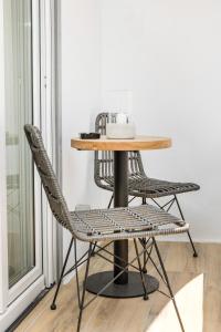 a table and chairs in a room with a window at Naxian Icon Luxury Residence 3 in Naxos Chora