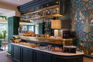 a buffet line with bread and pastries in a restaurant at La Perle in Paris