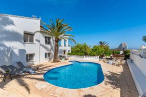 a swimming pool in the backyard of a villa at Villa Reva - PlusHolidays in Calpe