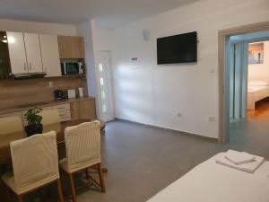 a living room with a kitchen and a table with chairs at Villa Anja Lux, Split in Split