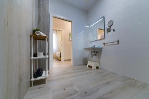 ein Badezimmer mit Waschbecken und Spiegel in der Unterkunft Holidays2Malaga Suites in Málaga + 91 Fotos