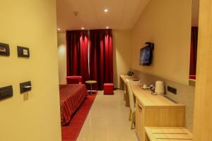 a room with a bed and a red curtain at Heliconia Park Port Harcourt Hotel and Suites in Port Harcourt