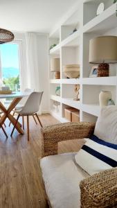 a living room with a table and a couch at Salt & Stone Villa in Pag