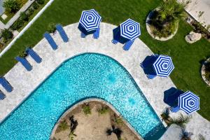 an overhead view of a pool with umbrellas and chairs at Paradise Garden in Kolimbia +42 photos