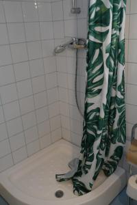 a shower with a green and white shower curtain at Casa Adriana in Eforie Sud +64 photos