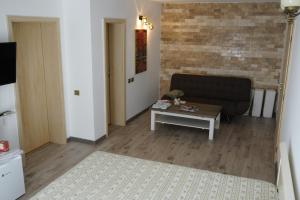 a living room with a couch and a coffee table at Casa Adriana in Eforie Sud