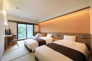 Una cama o camas en una habitación de KusatsuOnsen AeruyadoTakamatsu