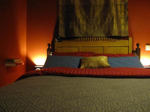 a bedroom with a large bed with two lamps at Treetop Apartment in The Hague