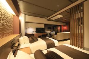 Una cama o camas en una habitación de KusatsuOnsen AeruyadoTakamatsu