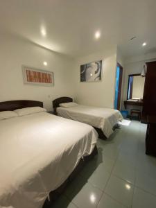 Ένα ή περισσότερα κρεβάτια σε δωμάτιο στο HOTEL MIRAMA 美麗華酒店