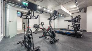 a gym with three exercise bikes in a room at Apartamenty Sun & Snow Jantaris in Mielno