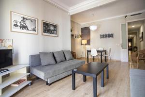 a living room with a couch and a table at 23PAR1007 Comfortable apartment in Paralel in Barcelona