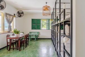a dining room with a table and a green floor at Homestay in Tay Ninh in Tây Ninh