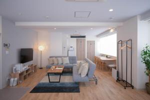 a living room with a couch and a table at RIVER VILLAS HIROSHIMA in Hiroshima