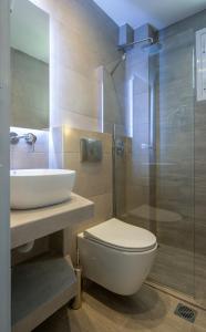 a bathroom with a toilet and a sink and a shower at Anastasia's House in Toroni +26 photos