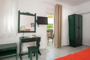 a room with a mirror and a dressing table and a television at Anastasia's House in Toroni