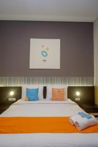 Krevet ili kreveti u jedinici u okviru objekta Sans Hotel Good Wish Semarang
