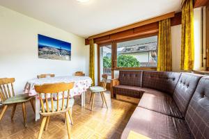 a living room with a table and a couch at Ciasa La Palsa App 2 in San Vigilio Di Marebbe