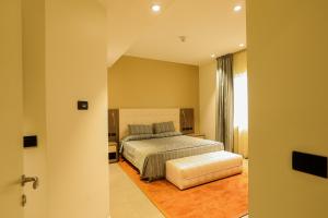 a large bedroom with a bed and a window at Heliconia Park Port Harcourt Hotel and Suites in Port Harcourt