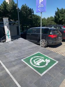 a parking lot with a handicapped sign next to a car at Hotel Heritage in Belgrade