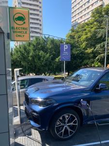 a blue car is parked at a parking meter at Hotel Heritage in Belgrade