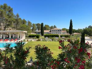 a large house with a swimming pool and a yard at Domaine de Valmouriane in Saint-Rémy-de-Provence