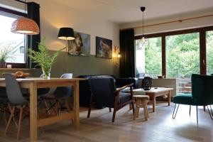 a living room with a dining room table and chairs at Elpe Apartments Hochsauerland in Elpe