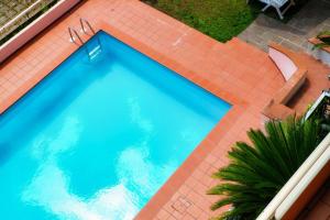 an overhead view of a swimming pool on a tile floor at JOIVY Villa Sofia in Como