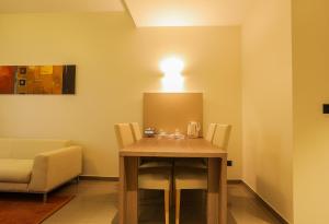 a dining room with a table and a light on the wall at Heliconia Park Port Harcourt Hotel and Suites in Port Harcourt