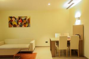 a living room with a couch and a table at Heliconia Park Port Harcourt Hotel and Suites in Port Harcourt
