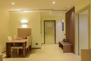 a dining room with a wooden table and chairs at Heliconia Park Port Harcourt Hotel and Suites in Port Harcourt