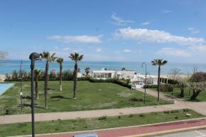 a house with palm trees and the ocean in the background at La Casa di Stella in Porto SantʼElpidio