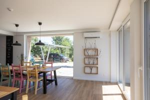 a dining room and living room with a table and chairs at Quinta da Sra Marocas in Covilhã