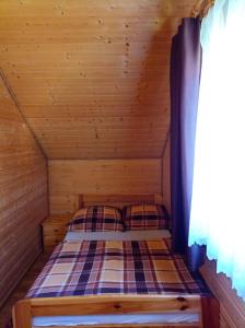 Posteľ alebo postele v izbe v ubytovaní Domki Komfort