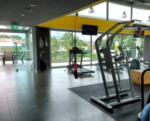 a gym with a treadmill in the middle of a room at Altamira Cozy apartment with amazing views in Santo Domingo